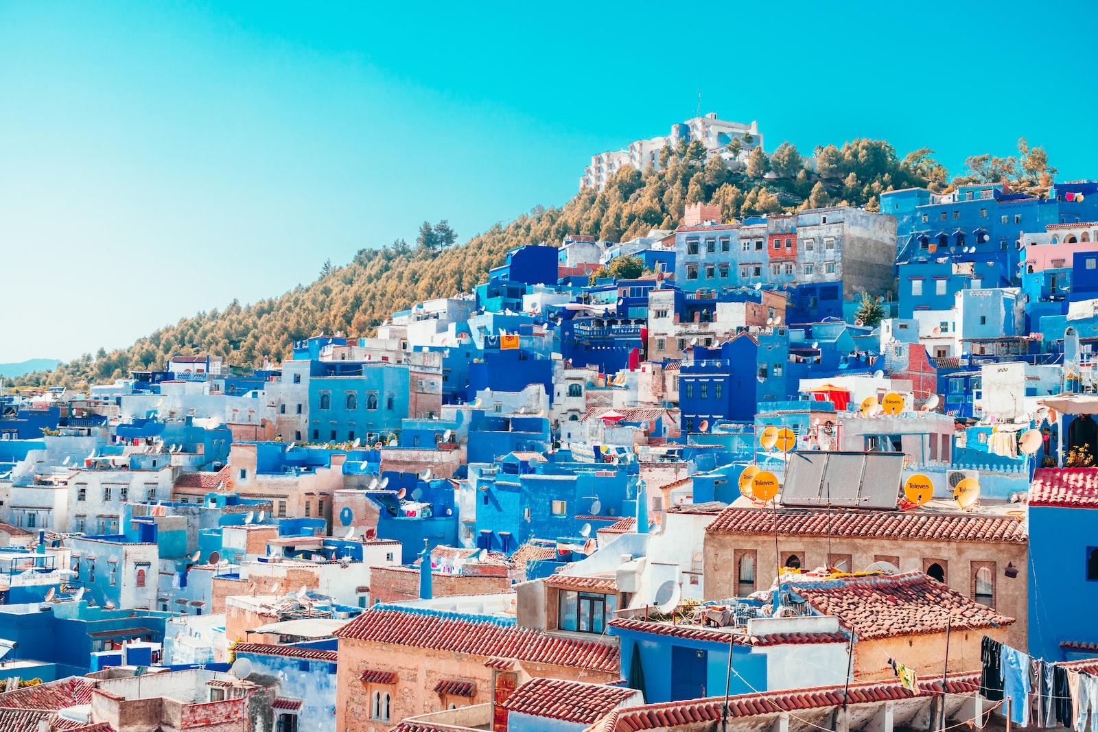 blue and white painted houses on the cliff
