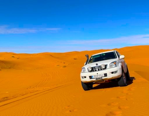 Participants resting at a desert camp during an Off-Road 4x4 Adventure in the Sahara Desert