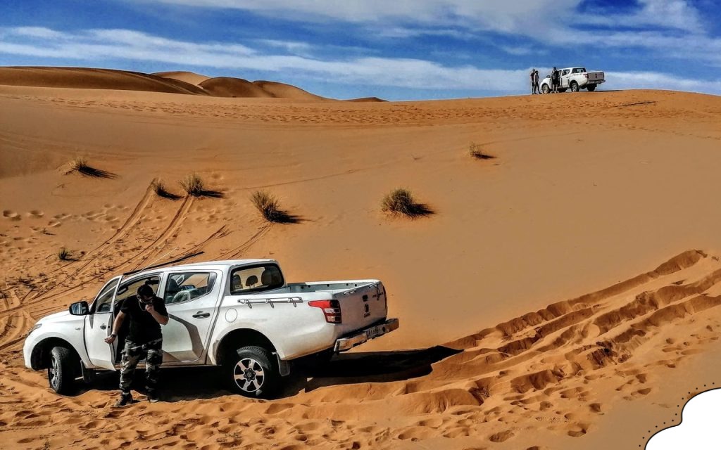 Off-Road 4x4 Adventure in the Sahara Desert during a stunning sunset over sand dunes