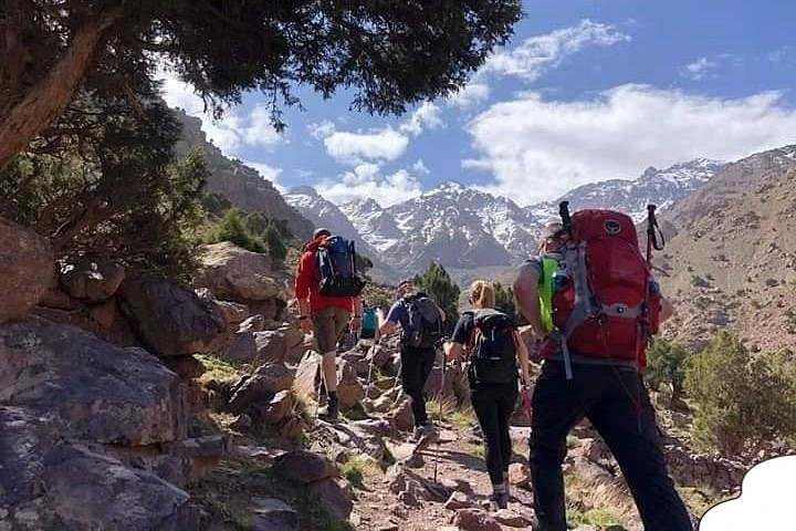 Hikers walking along a scenic trail in the Atlas Mountains.