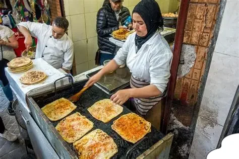 Freshly prepared Msemen pancakes at a Moroccan street food stall for Moroccan Street Food Guide.